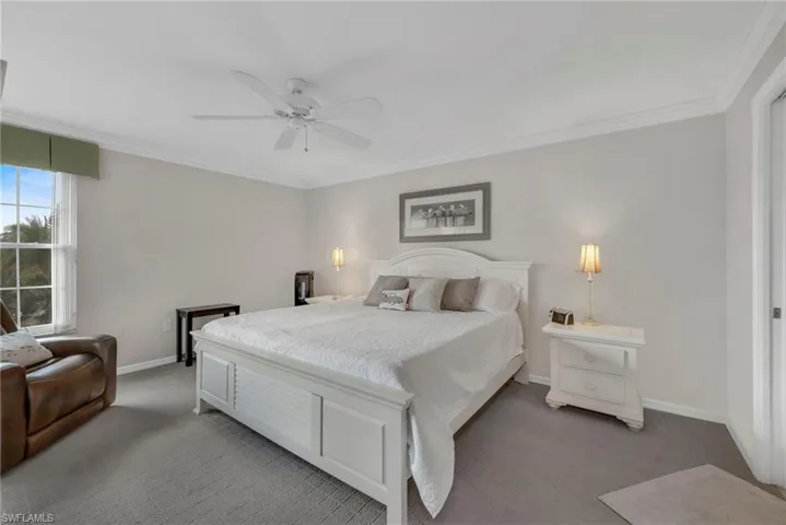 Bedroom with crown molding, carpet, and ceiling fan