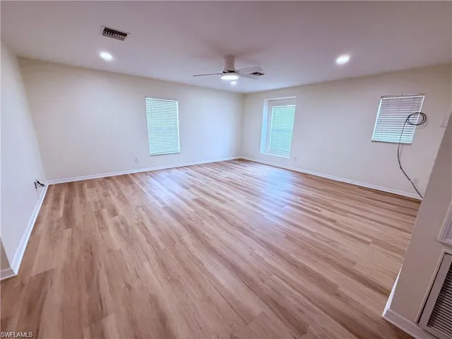 Unfurnished room with a ceiling fan, light wood finished floors, baseboards, and recessed lighting