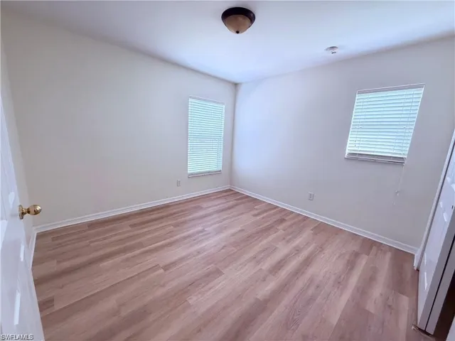 Empty room featuring light wood-type flooring and baseboards