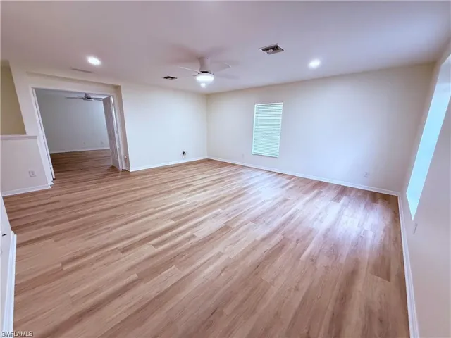 Empty room featuring a ceiling fan, recessed lighting, baseboards, and light wood finished floors
