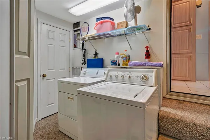 Laundry room with separate washer and dryer and huge storage area above