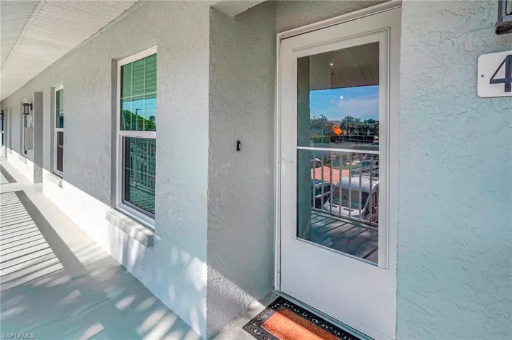Doorway to property with covered porch
