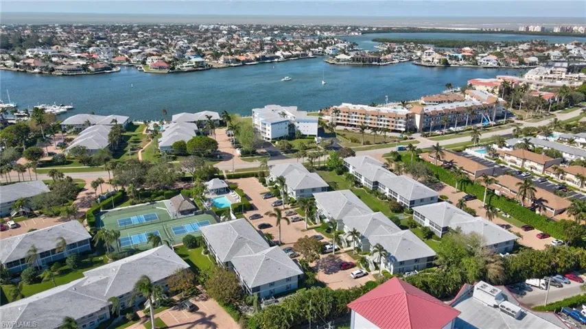 Birds eye view of property with a water view