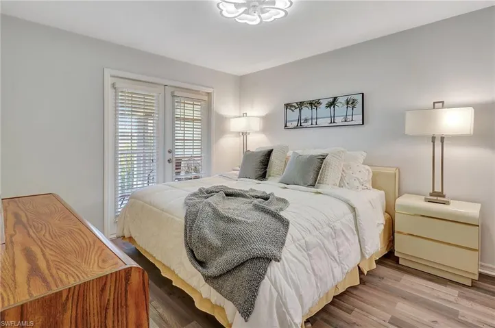 Bedroom featuring hardwood / wood-style flooring and access to outside