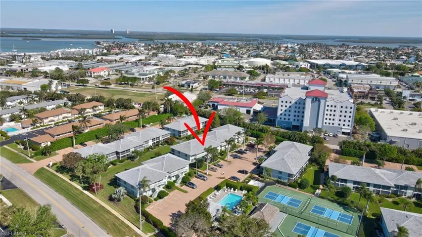 Birds eye view of property with a water view