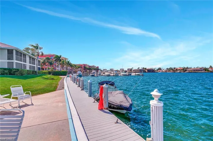Dock area featuring a lawn and a water view