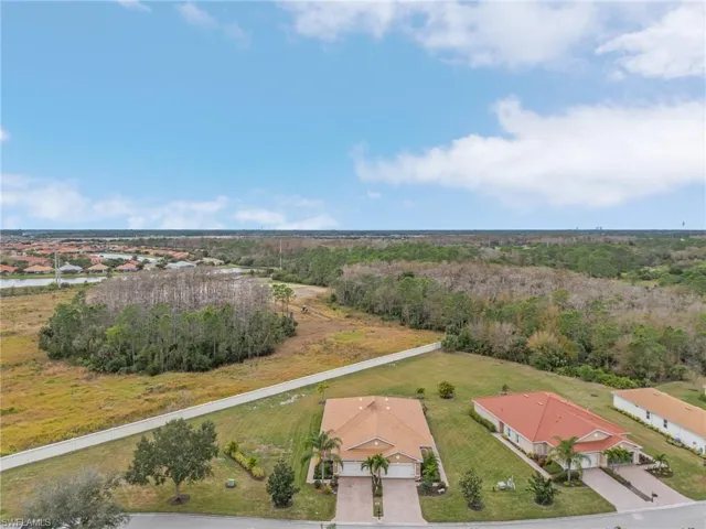 Aerial view of residential area featuring a heavily wooded area