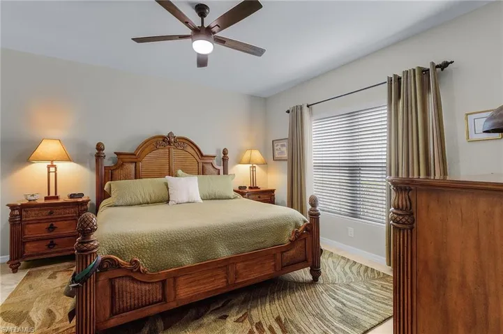 Bedroom featuring ceiling fan and baseboards