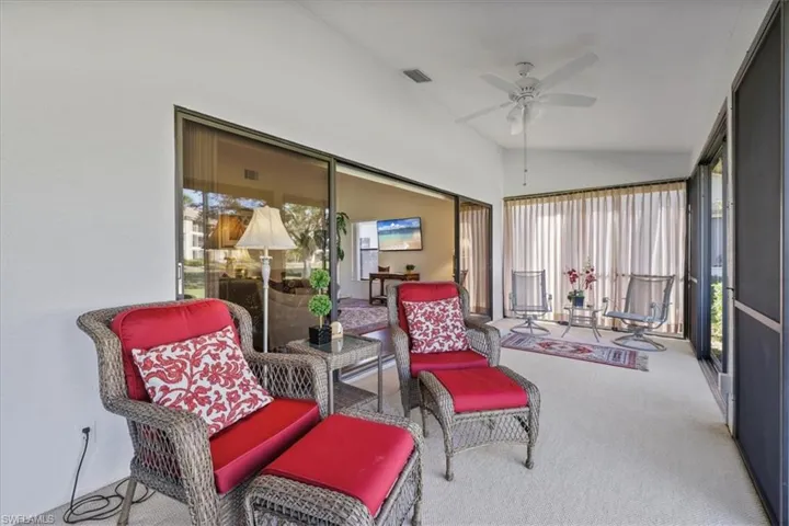 Sunroom featuring ceiling fan and vaulted ceiling