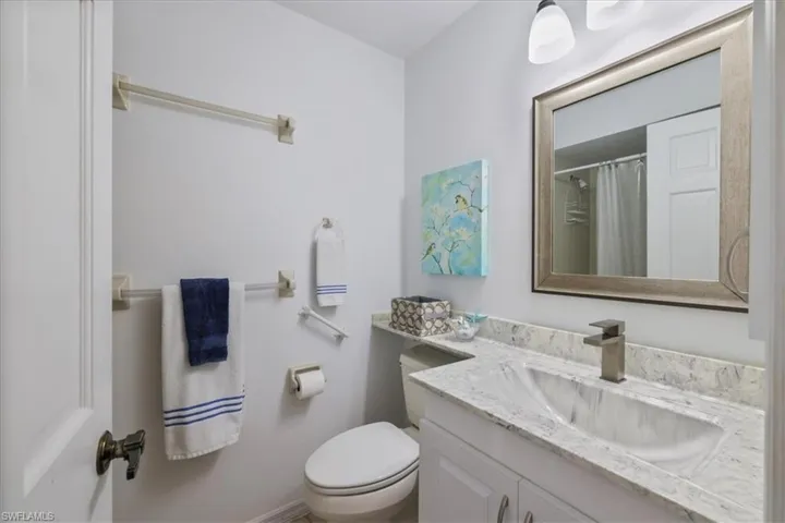 Bathroom featuring a shower with curtain and vanity