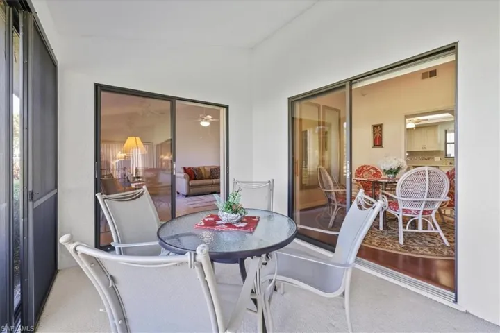 Sunroom / solarium with outdoor dining area and ceiling fan
