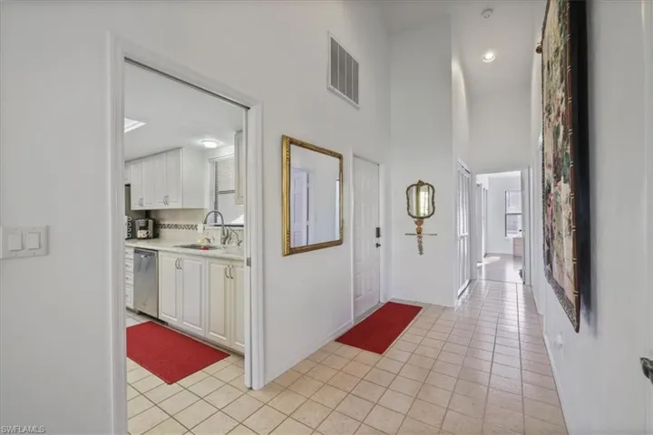 Entrance foyer featuring light tile patterned flooring and a high ceiling