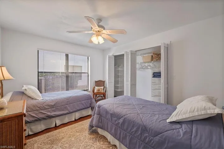 Bedroom with a ceiling fan and wood finished floors