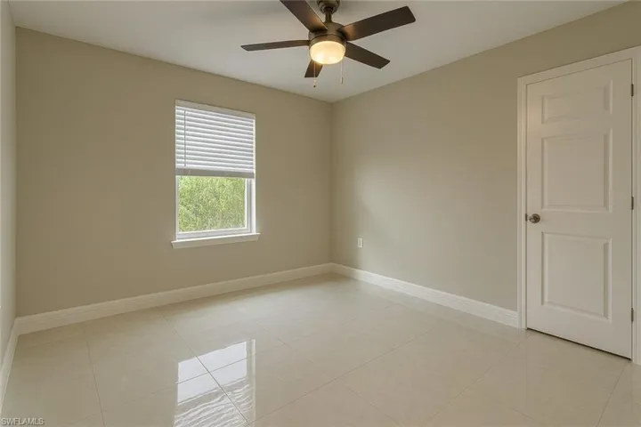 Spare room featuring light tile patterned floors and a ceiling fan