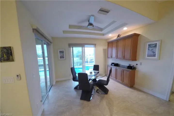 Dining area featuring a tray ceiling and ceiling fan