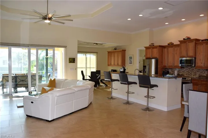 Living room with ceiling fan and crown molding