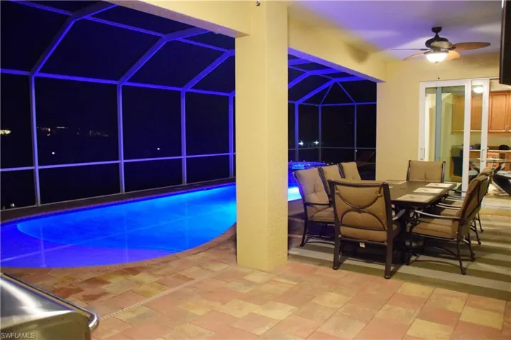 View of swimming pool with ceiling fan