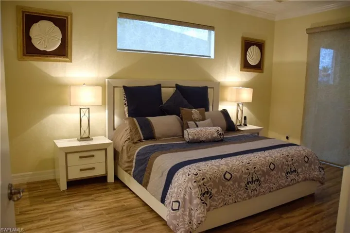 Bedroom featuring light hardwood / wood-style floors and crown molding