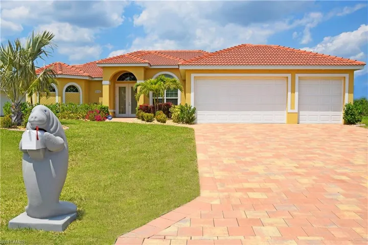Mediterranean / spanish home featuring french doors, a front yard, and a garage