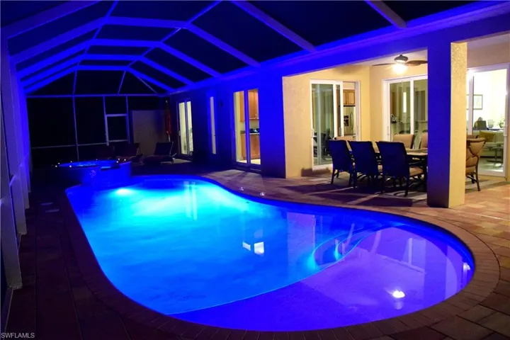 View of swimming pool with an in ground hot tub, french doors, ceiling fan, and a patio area