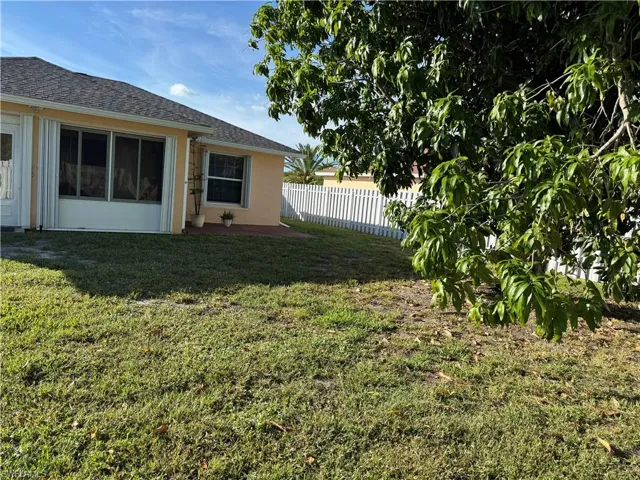 View of yard with a sunroom