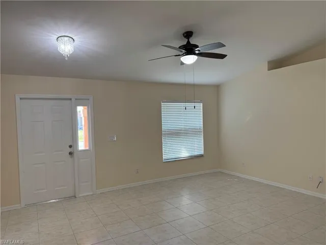 Entryway featuring healthy amount of natural light, a ceiling fan, and light tile patterned floors