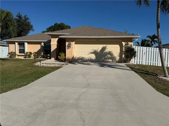 Single story home with stucco siding, driveway, an attached garage, and roof with shingles