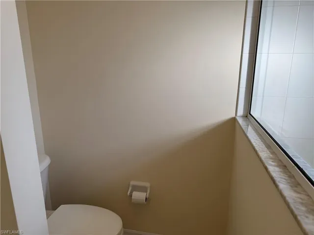 Half bath with toilet and baseboards