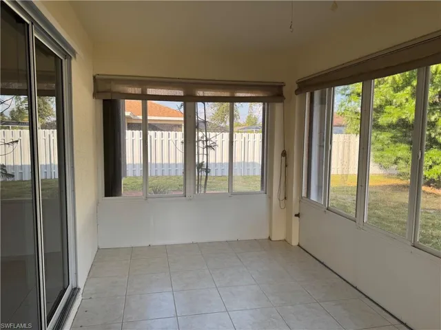 Unfurnished sunroom featuring tile patterned flooring