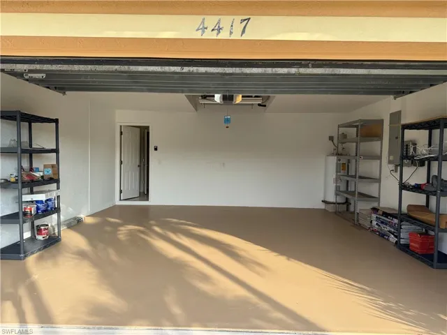 Garage with water heater and electric panel