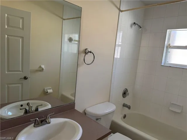 Full bathroom with shower / bath combination and vanity