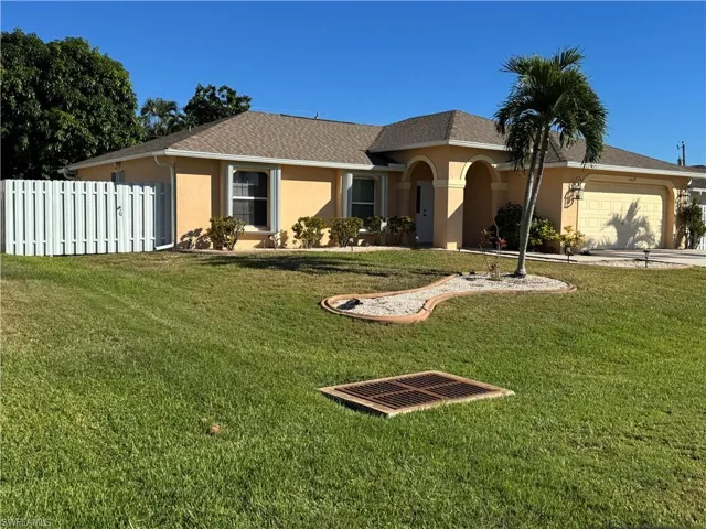 View of front of home featuring stucco siding, a garage, roof with shingles, and concrete driveway