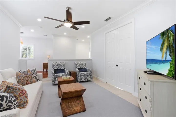 Comfortable den has pocket doors to create additional privacy when needed.
