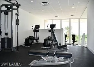 Exercise room with a drop ceiling and a wall of windows