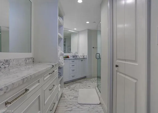 Marble Bathroom featuring vanity and a large glass shower.