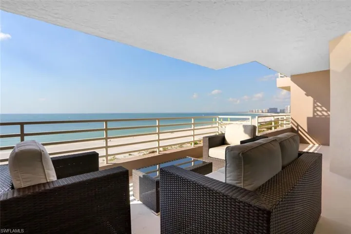 Balcony featuring a beach view, an outdoor