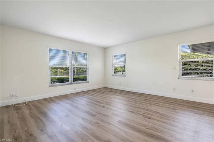 Empty room with light wood-type flooring and baseboards