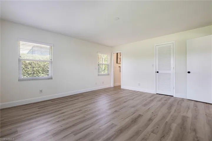 Unfurnished bedroom featuring light wood-style floors and a closet