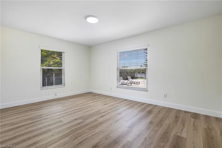 Spare room featuring light wood finished floors and healthy amount of natural light
