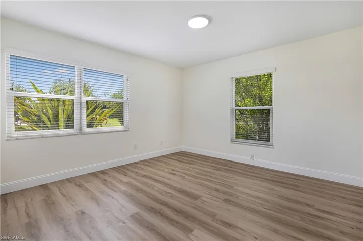 Unfurnished room featuring baseboards and wood finished floors