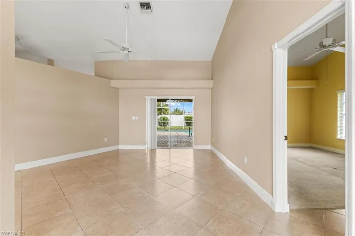 Empty room featuring visible vents, plenty of natural light, and ceiling fan