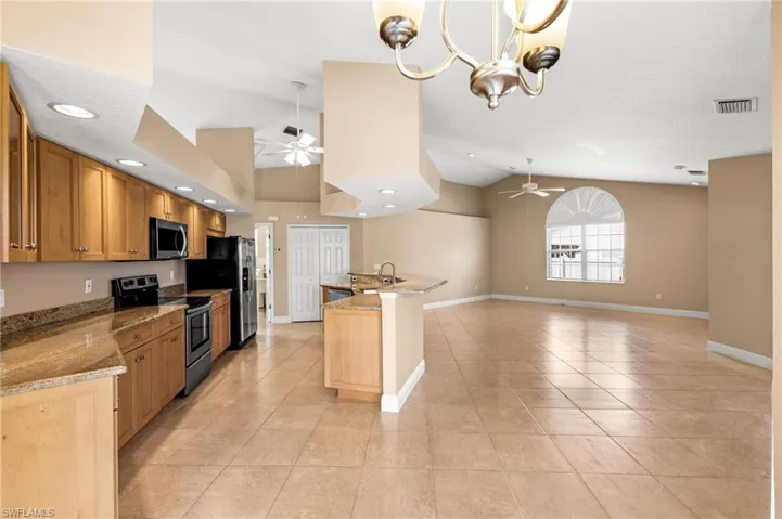 Kitchen featuring light tile patterned floors, a ceiling fan, stainless steel appliances, and visible vents