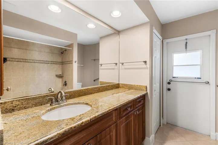 Full bathroom featuring walk in shower, toilet, recessed lighting, vanity, and tile patterned flooring