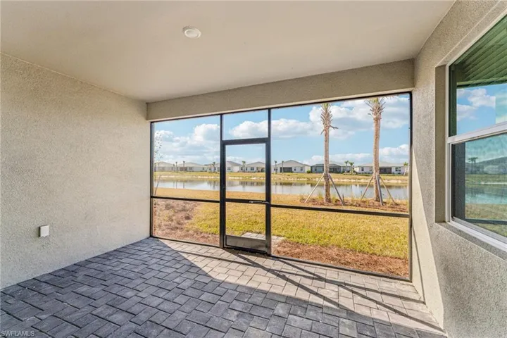 Unfurnished sunroom featuring a water view