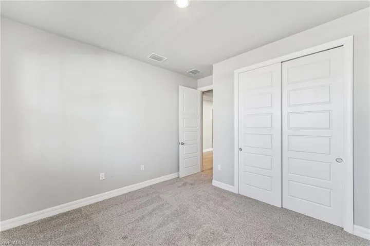 Unfurnished bedroom with carpet floors and a closet