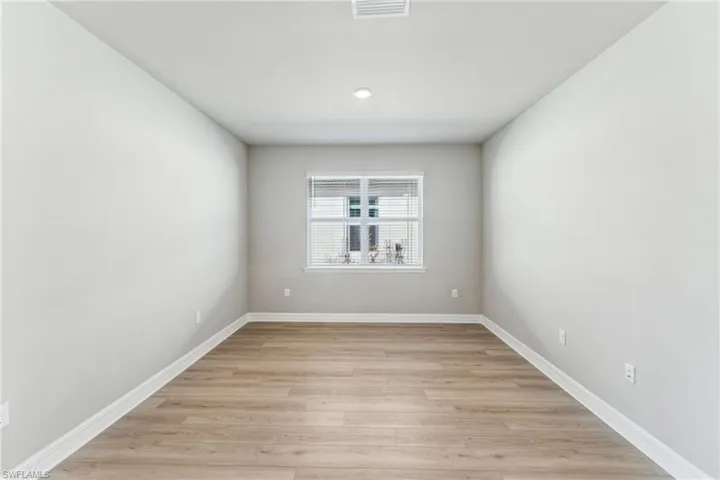 Empty room with light hardwood / wood-style floors