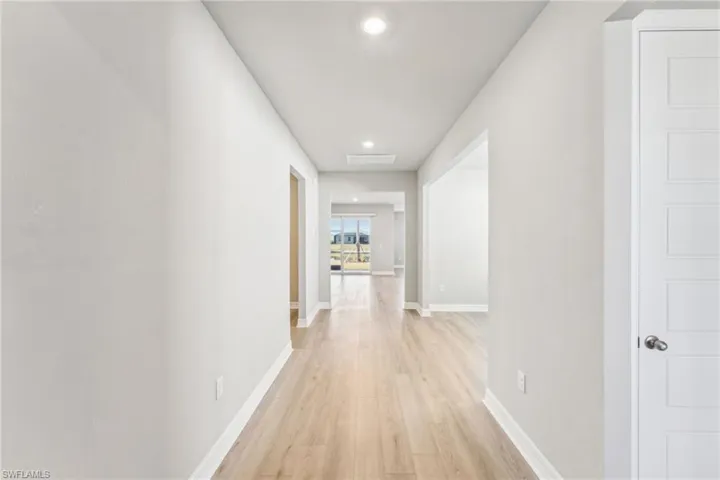 Corridor with light hardwood / wood-style floors