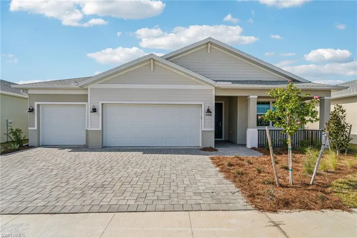 View of front of property with a garage and a porch
