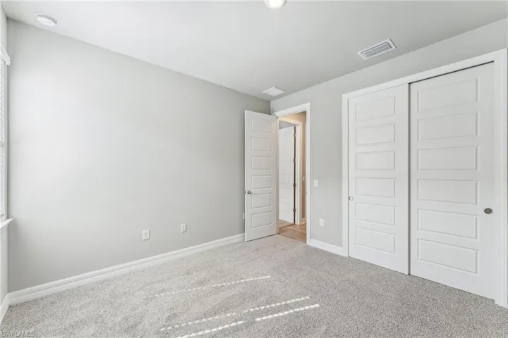 Unfurnished bedroom featuring carpet floors and a closet