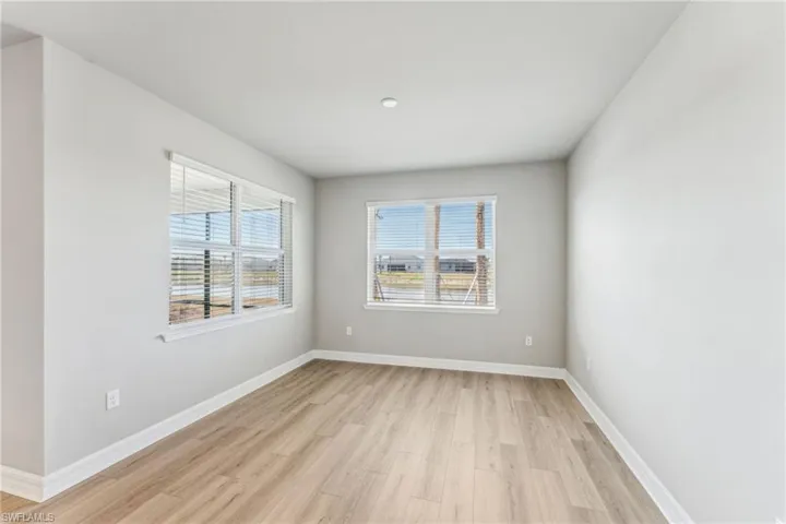 Spare room featuring a wealth of natural light and light wood-type flooring